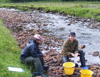 Colin Macdonald with wild salmon parr in the Glenmore River headwaters, July 2009.
